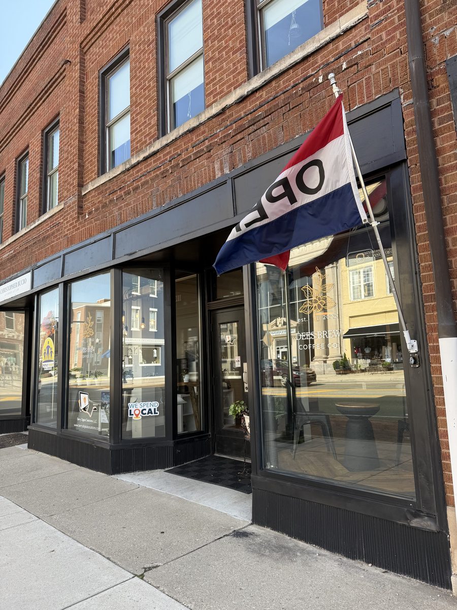 The corner storefront of Dees Brew Coffee Co. on North Main Street, an Ohio flag over the door